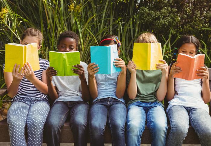 group of kids with multicolored books